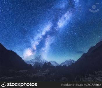 Milky Way. Amazing scene with himalayan mountains and starry sky at night in Nepal. High rocks with snowy peak and sky with stars. Beautiful Manaslu, Himalayas. Night landscape with bright milky way. Milky Way. Amazing scene with himalayan mountains