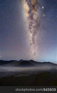 Milky way and stars above Mount Bromo at night. An active volcano and one of the most visited tourist attractions in east Java from viewpoint, Indonesia. Astronomy.
