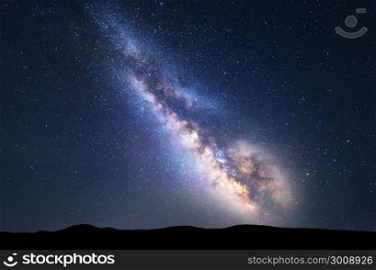 Milky Way. Colorful night landscape with bright milky way, starry sky and hills in summer. Space background. Amazing astrophotography. Beautiful universe. Travel