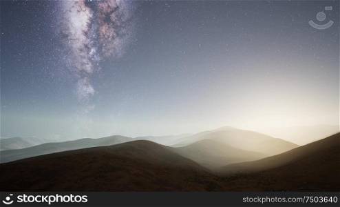 Milky Way stars above desert mountains