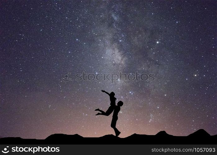 Milky Way with silhouette of people.Love on milky way