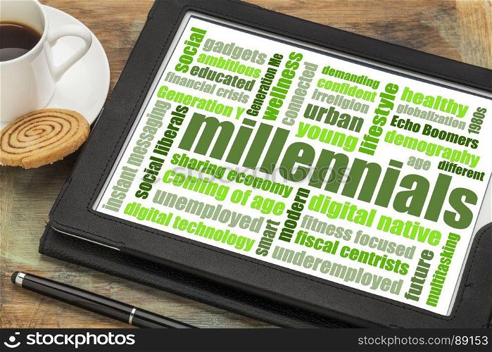 millennials generation word cloud on a digital tablet with a cup of coffee - demography concept