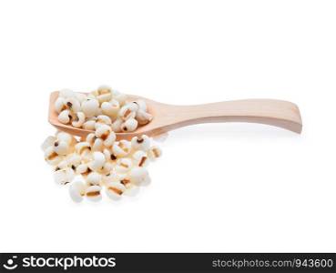 Millet grains in wooden spoon isolated on white background