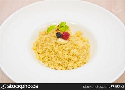 Millet porridge with berry closeup