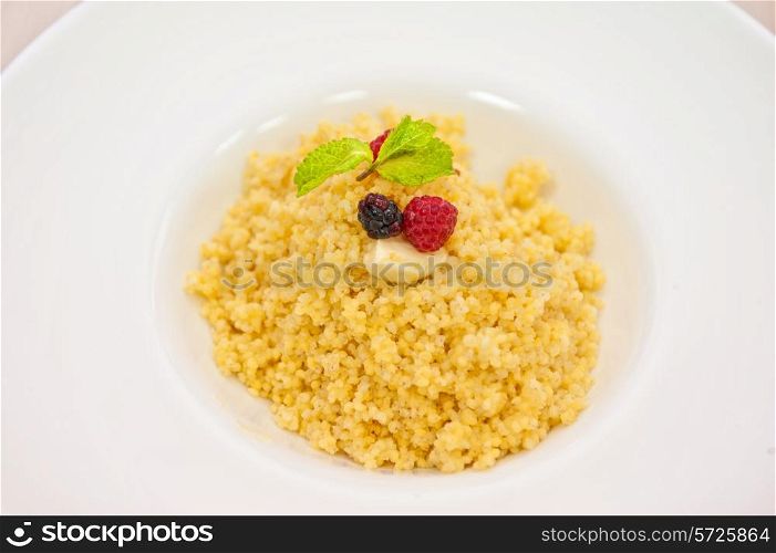 Millet porridge with berry closeup