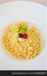Millet porridge with berry closeup. Millet porridge