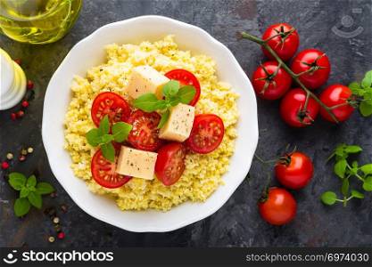 Millet porridge with tomatoes and cheese