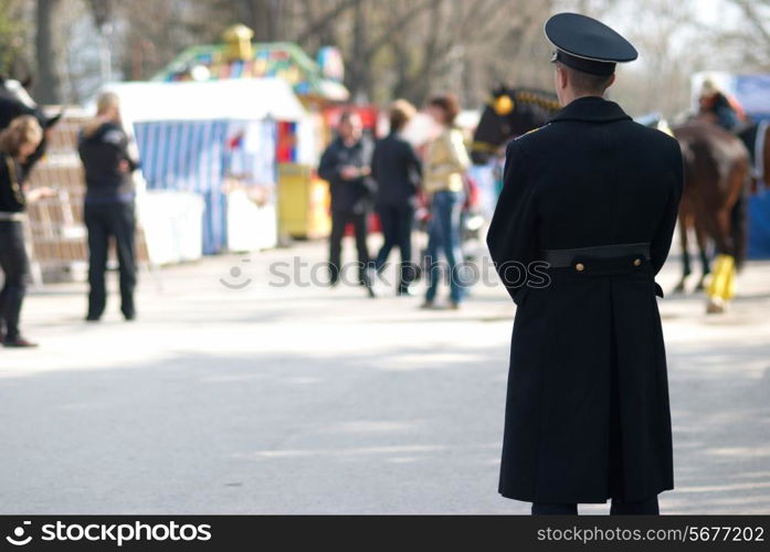 Millitary man looking at the walking people