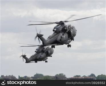 Miltary helicopter pair in flight