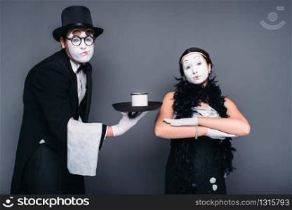 Mime actors comedy performing with a glass of water. Pantomime theater performers