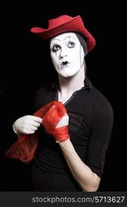 Mime in a red cowboy hat on a black background