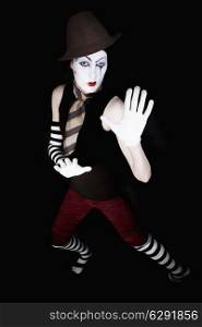 mime in hat, tie and white gloves on black background