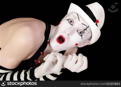 mime in striped gloves and white hat isolated on black background closeup