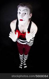Mime with a big red bow on a black background