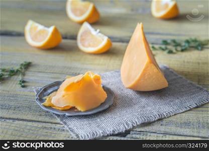 Mimolette cheese on the wooden board