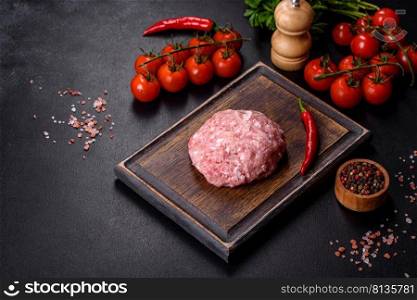 Mince. Ground meat with ingredients for cooking on black background. Top view. Ground meat with ingredients for cooking on black background