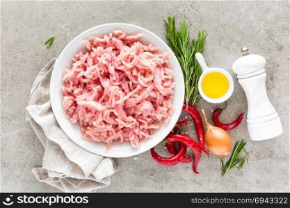 Mince. Ground meat with ingredients for cooking on light grey background. Top view