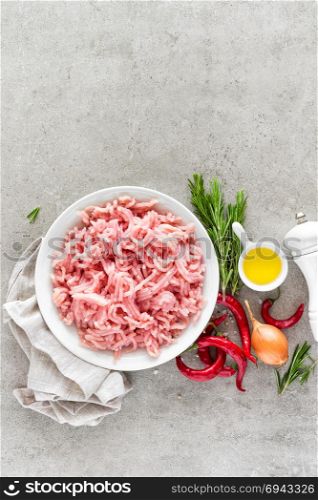 Mince. Ground meat with ingredients for cooking on light grey background. Top view