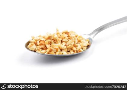 Minced hazelnuts on spoon