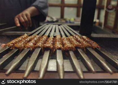 Minced meat being barbecued at street stall
