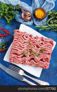 minced meat on plate and on a table