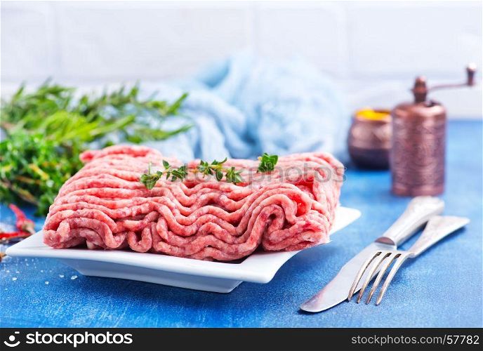 minced meat on plate and on a table