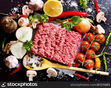 minced meat with vegetables on dark board