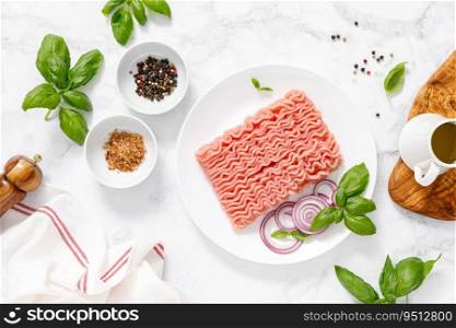 Mincemeat, forcemeat. Minced meat with ingredients for cooking, top view