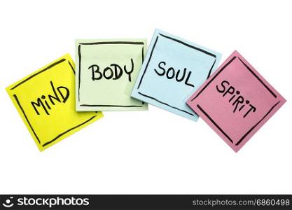 mind, body, soul, and spirit concept - handwriting in black ink on isolated sticky notes