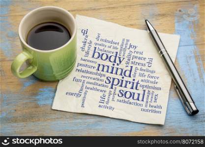 mind, body, spirit and soul concept - word cloud on a napkin with a cup of coffee