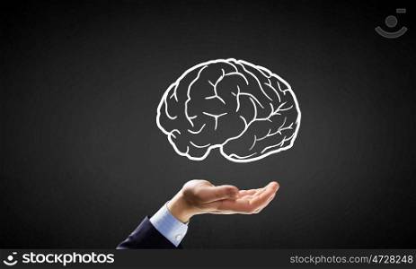 Mind in hand. Person hand holding human brain in palm