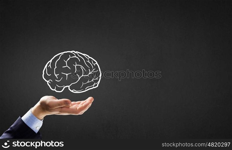 Mind in hand. Person hand holding human brain in palm