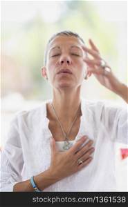 Mindful woman meditating, developing intuition. Hand gesture. . Intuition Meditation Hand Gesture