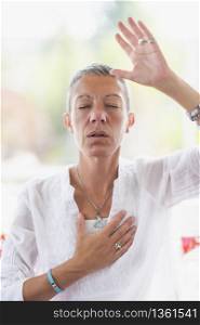 Mindful woman meditating, developing intuition. Hand gesture. . Intuition Meditation Hand Gesture