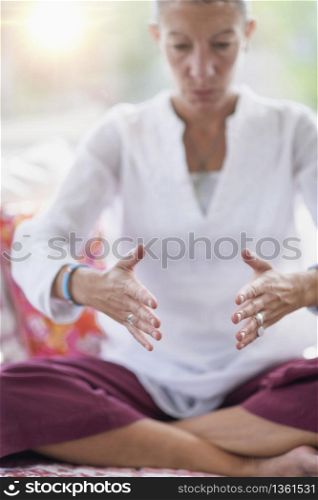 Mindful woman meditating, improving mental focus. . Improving Mental Focus Meditation Hand Gesture