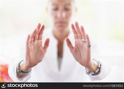 Mindful woman performing respect gesture with her hands. Spiritual awakening.. Respect