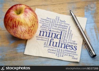 mindfulness word cloud on a napkin with a fresh apple