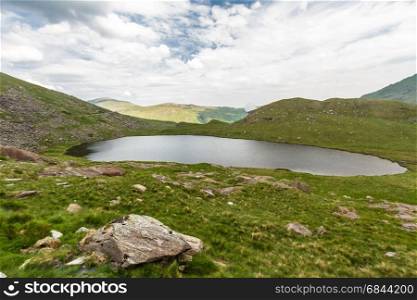 Miners track to summit of Snowdon passing LLyn Teryn lake and ruins. Snowdonia, Wales, United Kingdom.