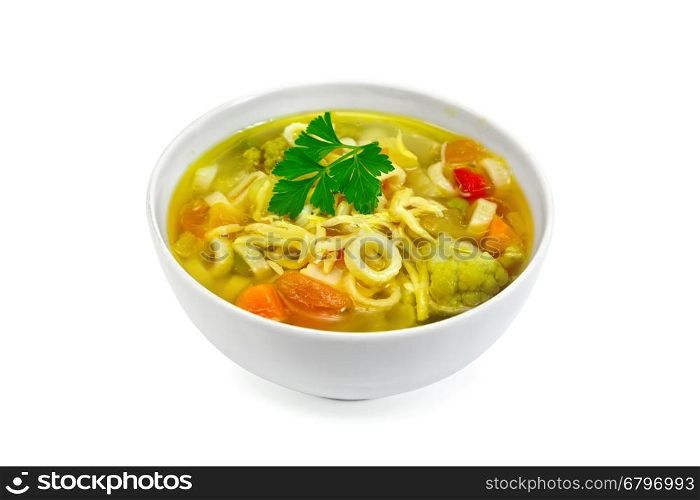 Minestrone soup with meat, celery, tomatoes, zucchini and cabbage, green peas, carrots and pasta in a bowl isolated on white background