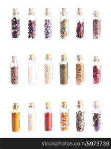 Mini bottles with spices isolated on white. Set of eighteen objects. Mini bottles with spices