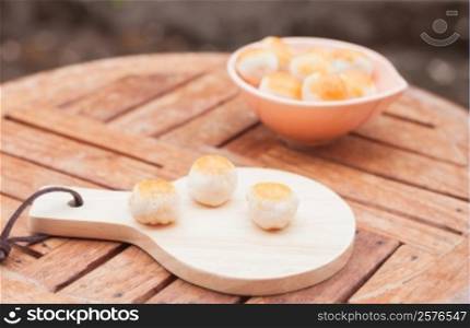 Mini Chinese cakes on wooden plate, stock photo