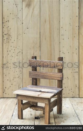 mini model chair with wooden wall