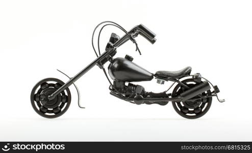 Mini motorcycle made from wire and different motorcycle parts, on white background