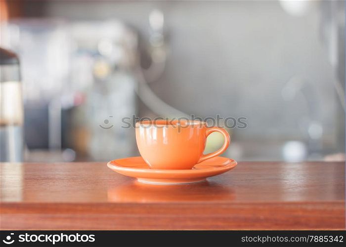 Mini orange coffee cup in coffee shop, stock photo