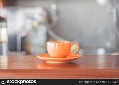 Mini orange coffee cup in coffee shop, stock photo