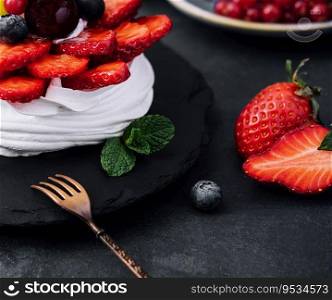 Mini pavlova meringue cake decorated with fresh berries
