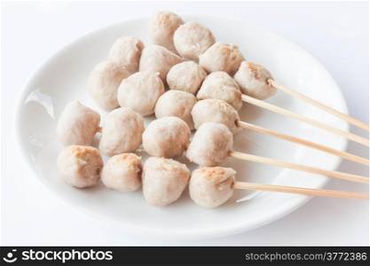 Mini pork balls in white plate on clean table