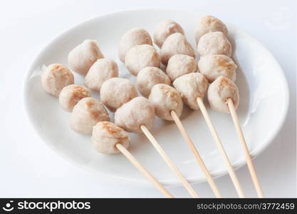 Mini pork balls in white plate on clean table