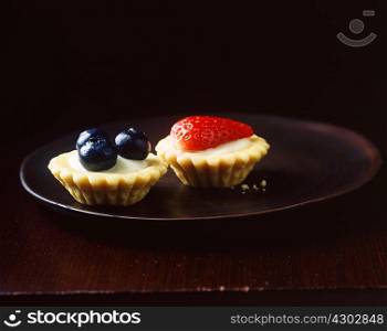 Mini summer fruit tarts on plate