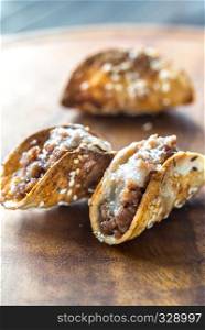 Mini tacos with ground beef, mozzarella and parmesan
